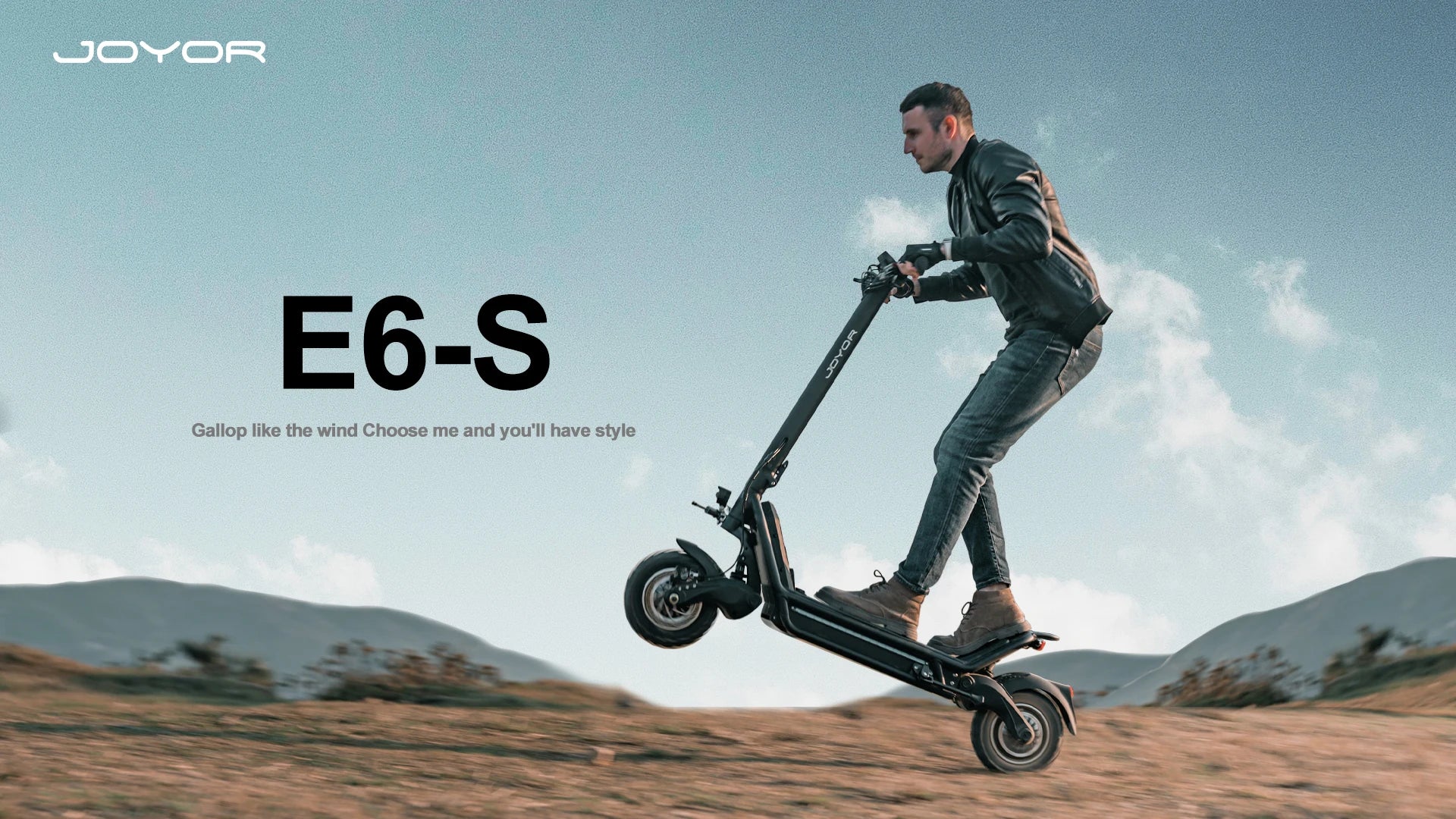 Rider using the Joyor E6-S electric mountain scooter on a trail