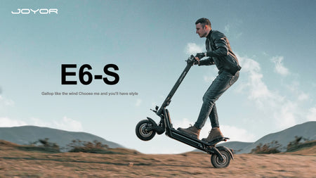 Rider using the Joyor E6-S electric mountain scooter on a trail