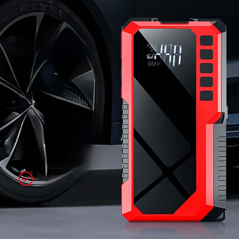 Car emergency start power supply and air pump all-in-one machine next to a car wheel.